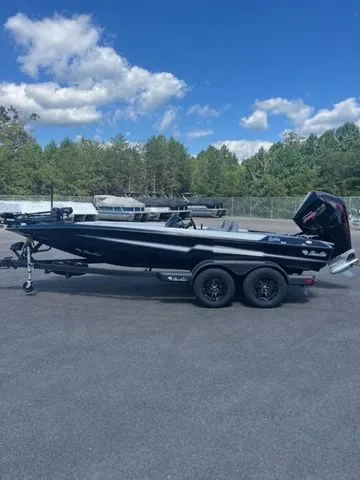 Slide: The Image of 2026 Bass Cat Pantera Classic boat on trailer, parked outdoors under blue sky. - 1
