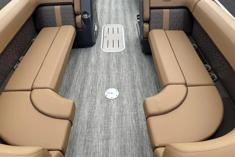 Slide: The Image of 2026 Bennington M Quad Bench 24 MSL interior with luxurious tan seating and gray flooring. - 14
