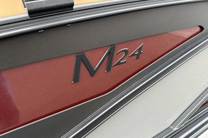Slide: The Image of Close-up of 2026 Bennington M Quad Bench 24 MSL boat model emblem. - 15