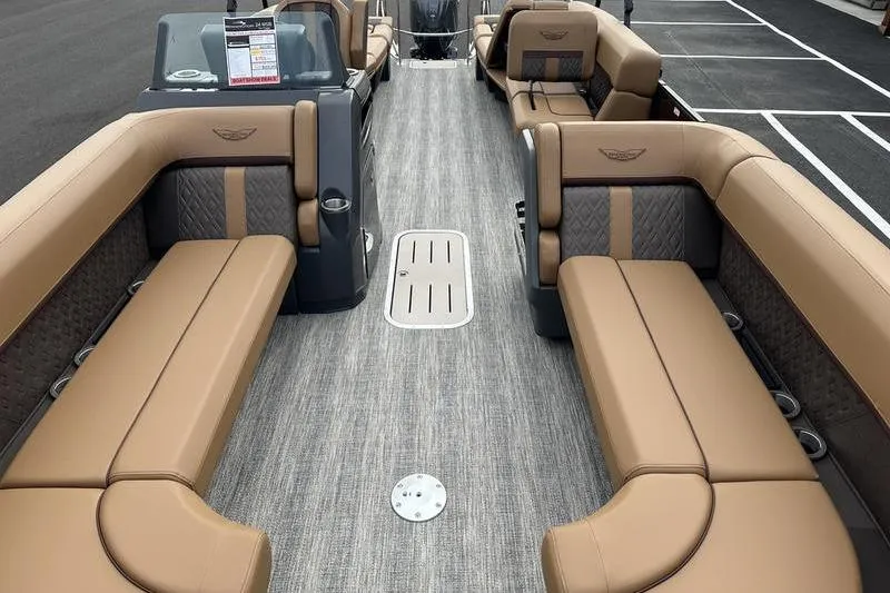 Slide: The Image of 2026 Bennington M Quad Bench 24 MSL pontoon boat with luxurious tan seating and sleek design. - 17