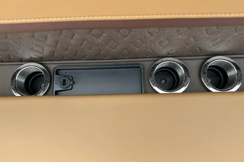 Slide: The Image of Interior of 2026 Bennington M Quad Bench 24 MSL with cup holders and storage compartment. - 22