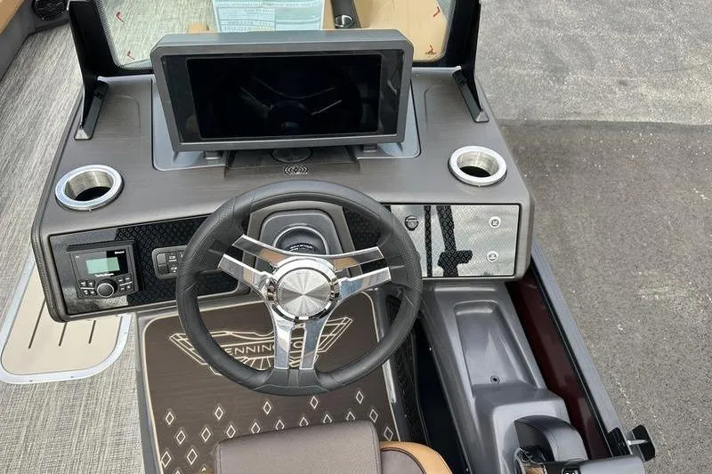Slide: The Image of 2026 Bennington M Quad Bench 24 MSL boat dashboard with steering wheel and digital display. - 27