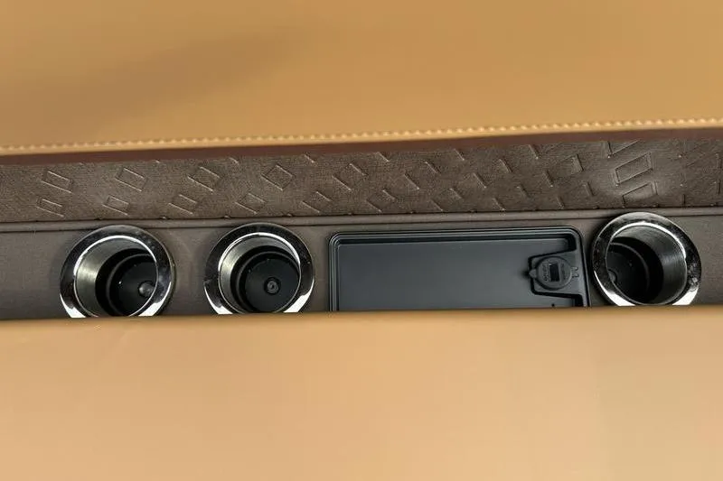 Slide: The Image of Interior view of 2026 Bennington M Quad Bench 24 MSL with cup holders and storage compartment. - 30