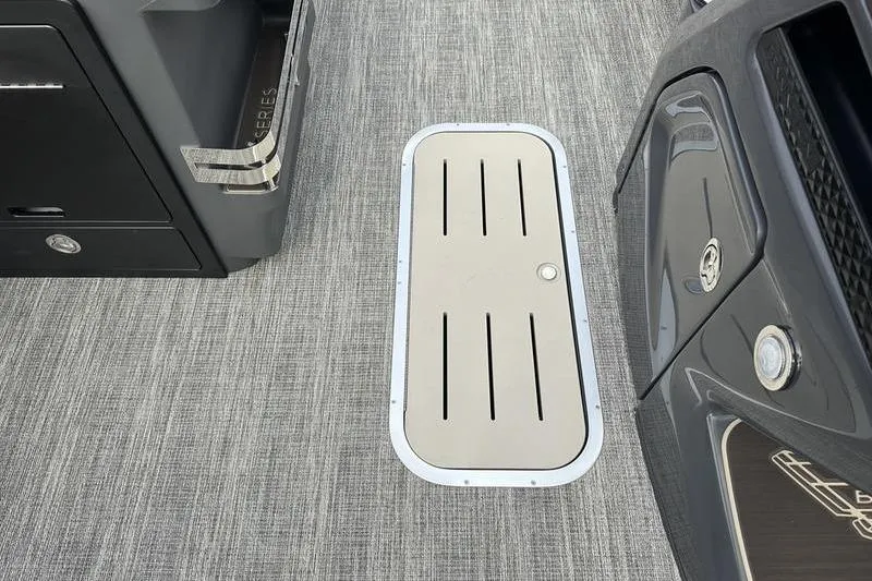 Slide: The Image of 2026 Bennington M Quad Bench 24 MSL boat interior with sleek flooring and storage compartment. - 37