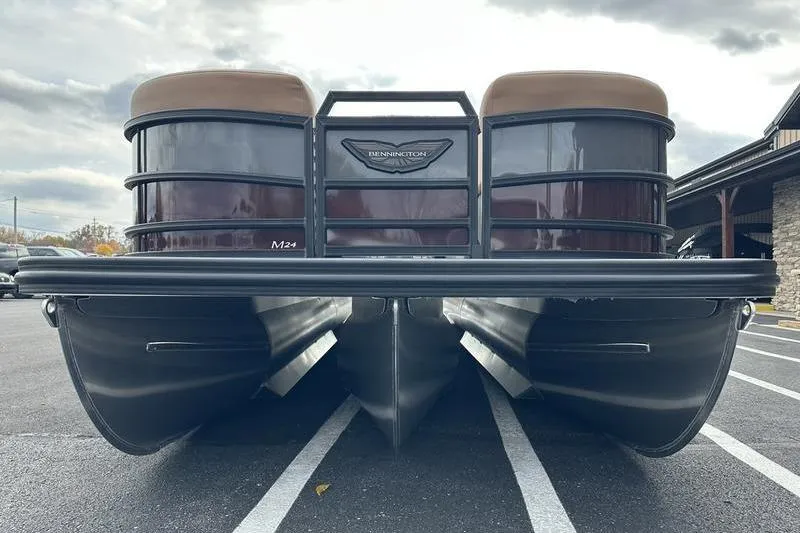 Slide: The Image of 2026 Bennington M Quad Bench 24 MSL pontoon boat, rear view in parking lot. - 4