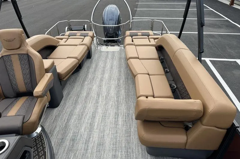 Slide: The Image of 2026 Bennington M Quad Bench 24 MSL pontoon boat with luxurious tan seating and modern design. - 48