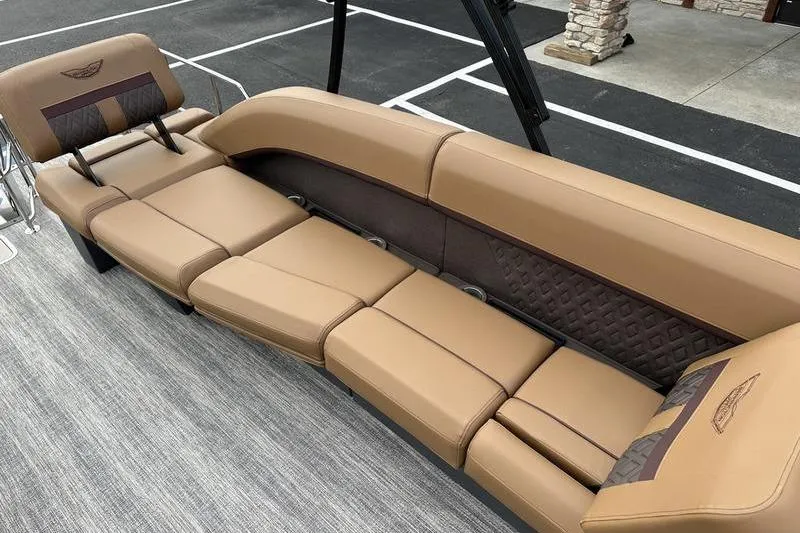 Slide: The Image of 2026 Bennington M Quad Bench 24 MSL with luxurious tan seating on a boat deck. - 55