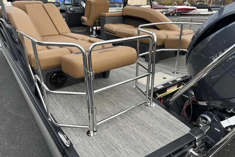 Slide: The Image of 2026 Bennington M Quad Bench 24 MSL boat with tan seating and chrome railings. - 7