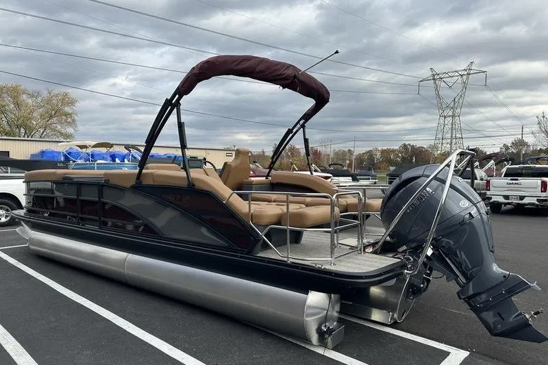 Slide: The Image of 2026 Bennington M Quad Bench 24 MSL pontoon boat with Yamaha outboard motor in parking lot. - 8