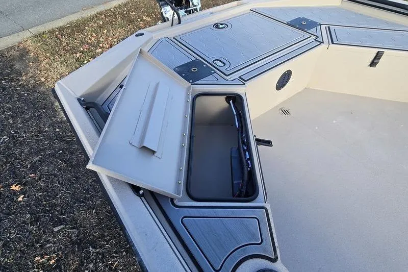 Slide: The Image of 2026 Avid 18 Commander boat on trailer with Yamaha engine, parked outdoors. - 3