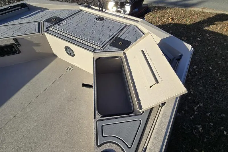 Slide: The Image of 2026 Avid 18 Commander boat deck with storage compartments and fishing rod holders. - 6