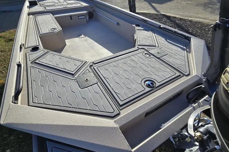 Slide: The Image of Open battery compartment in 2026 Avid 18 Commander boat, showing wiring and storage. - 7