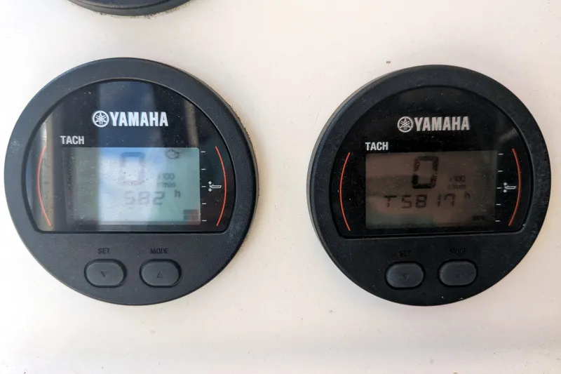 Slide: The Image of Yamaha tachometers on a 2013 Cobia 296 Center Console boat dashboard. - 10
