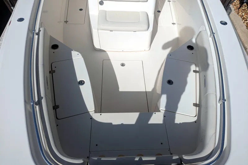 Slide: The Image of 2013 Cobia 296 Center Console boat interior with seating and storage compartments. - 18