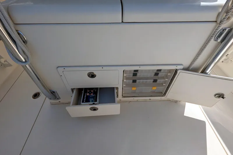 Slide: The Image of 2013 Cobia 296 Center Console storage compartments with open drawers and doors. - 23
