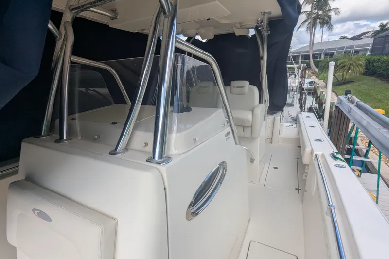 Slide: The Image of 2013 Cobia 296 Center Console boat docked, featuring sleek design and spacious deck. - 30