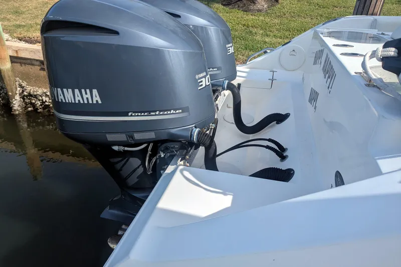 Slide: The Image of 2013 Cobia 296 Center Console with twin Yamaha 300 four-stroke engines. - 32