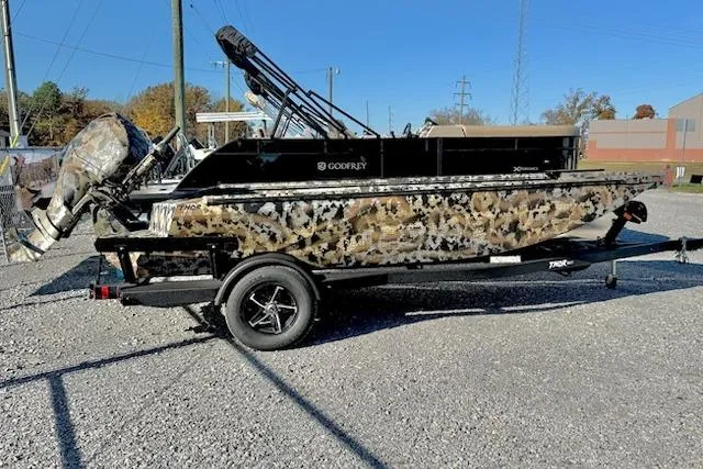 The Image of Camouflage-patterned Thor TIMBER HAMMER 1754 boat on trailer, 2026 model, parked outdoors. - 1