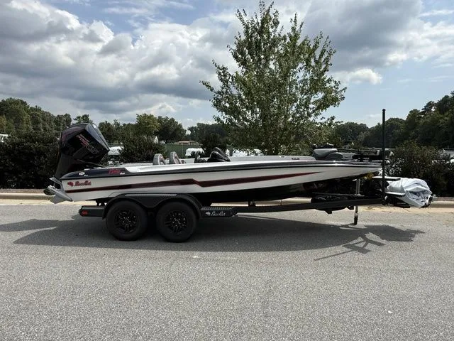 The Image of 2026 Bass Cat Pantera Classic boat on trailer, parked outdoors under cloudy sky. - 1
