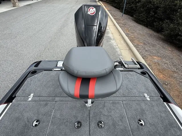 Slide: The Image of 2026 Bass Cat Pantera Classic boat seat with red stripe, gray upholstery, and motor in background. - 12