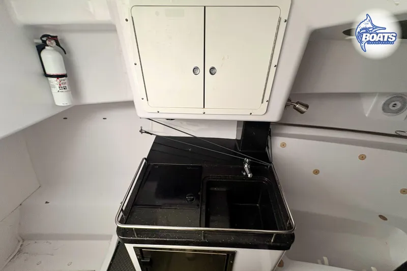 Slide: The Image of 2008 Southport 28 Express cabin interior with kitchenette and seating area. - 10