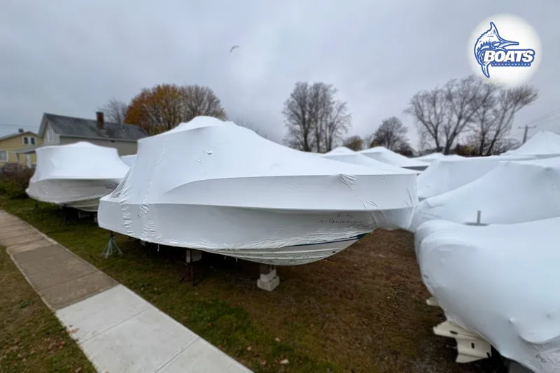 Slide: The Image of 2008 Southport 28 Express boats covered for winter storage in a residential area. - 19