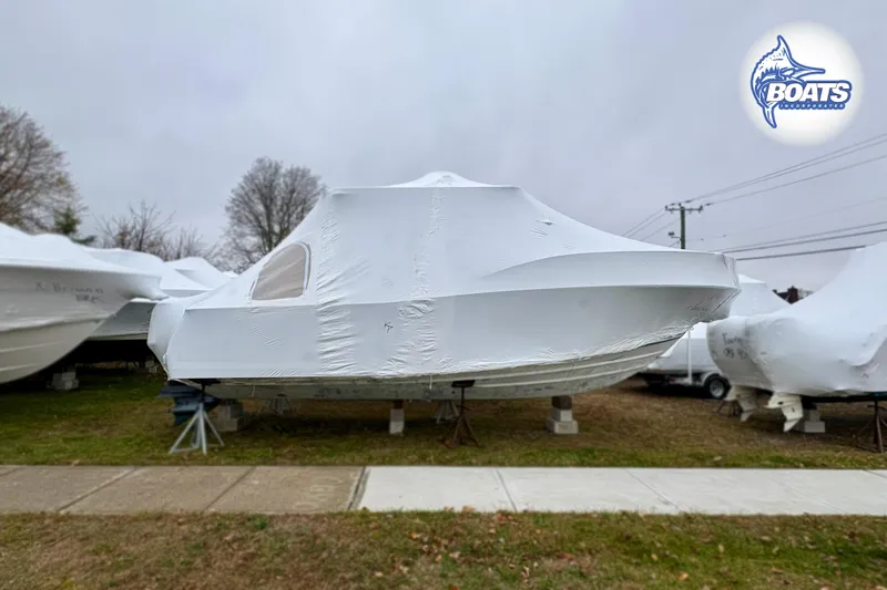 Slide: The Image of 2008 Southport 28 Express boat covered in white tarp, stored outdoors. - 20