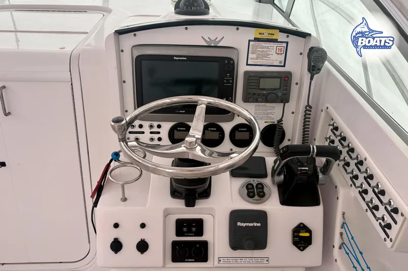 Slide: The Image of Cockpit of 2008 Southport 28 Express boat with steering wheel and navigation controls. - 8