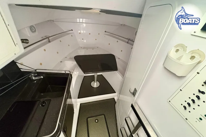 Slide: The Image of 2008 Southport 28 Express boat helm with steering wheel, Raymarine electronics, and Yamaha controls. - 9