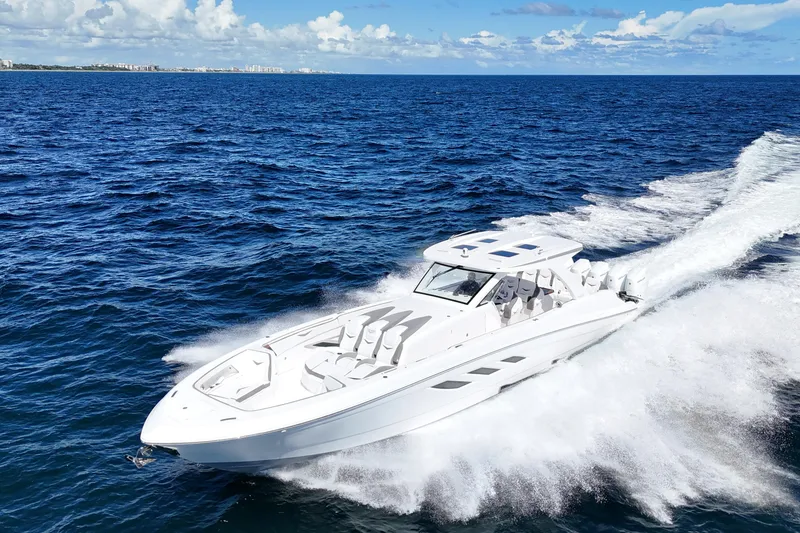 Slide: The Image of Luxury 2026 Deep Impact 499 Sport boat cruising near a scenic lighthouse. - 10