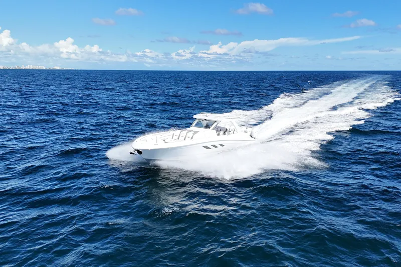 Slide: The Image of Luxury yacht Deep Impact 499 Sport, 2026 model, cruising near a scenic lighthouse. - 11