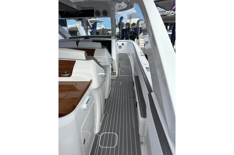 Slide: The Image of Luxury 2026 Deep Impact 499 Sport boat cruising on a scenic waterfront. - 17