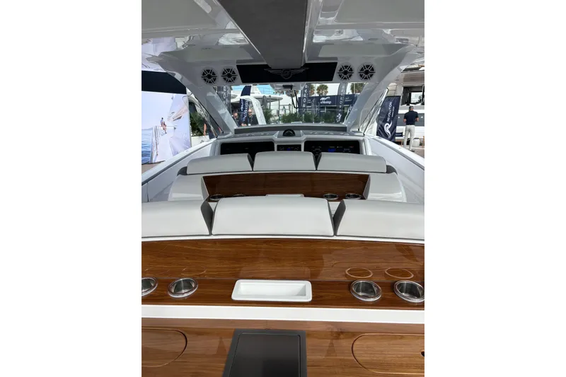 Slide: The Image of 2026 Deep Impact 499 Sport Luxury Edition boat on shimmering water. - 18