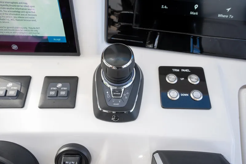 Slide: The Image of Control panel of 2026 Deep Impact 499 Sport Luxury Edition boat with navigation and trim controls. - 49
