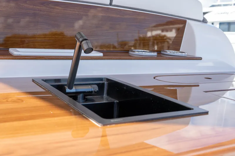Slide: The Image of Luxury yacht sink on Deep Impact 499 Sport, 2026 model, with sleek wood finish. - 54