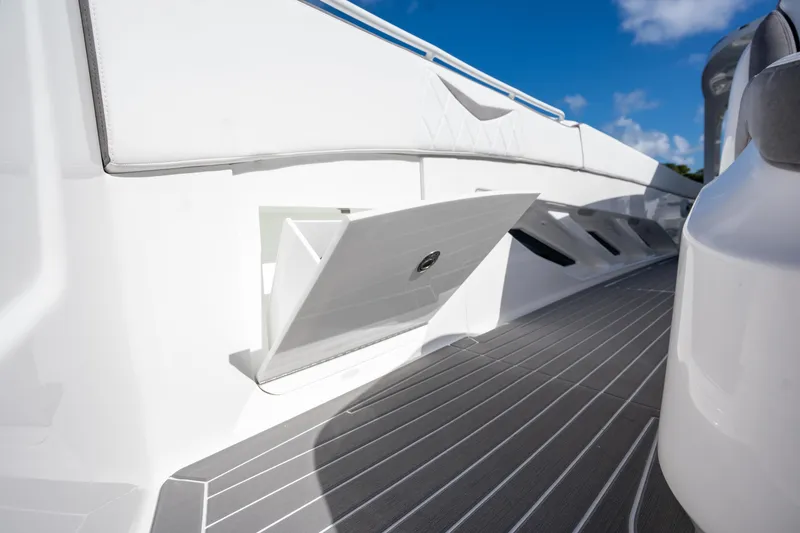 Slide: The Image of 2026 Deep Impact 499 Sport Luxury Edition boat interior with sleek white design and storage compartment. - 58