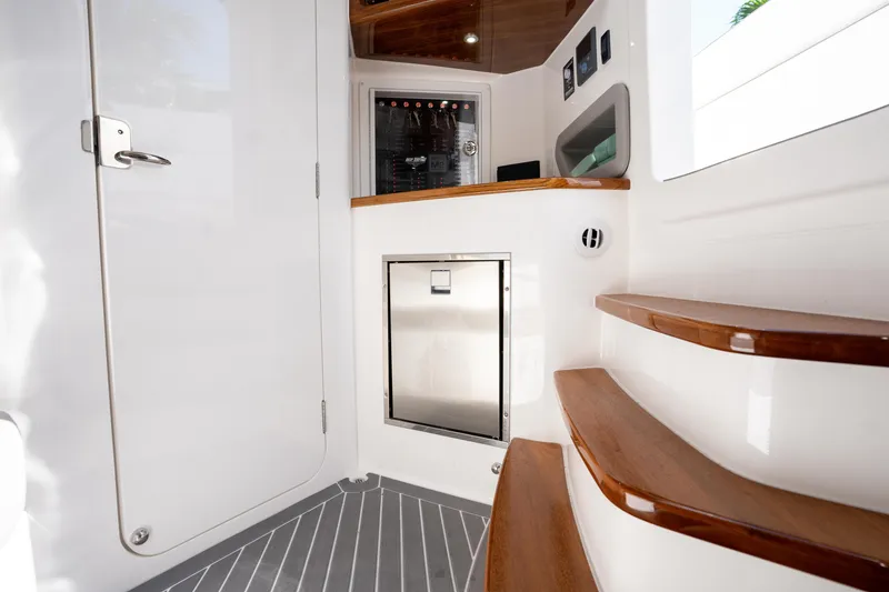 Slide: The Image of Luxurious interior of 2026 Deep Impact 499 Sport Luxury Edition boat with wooden steps. - 62