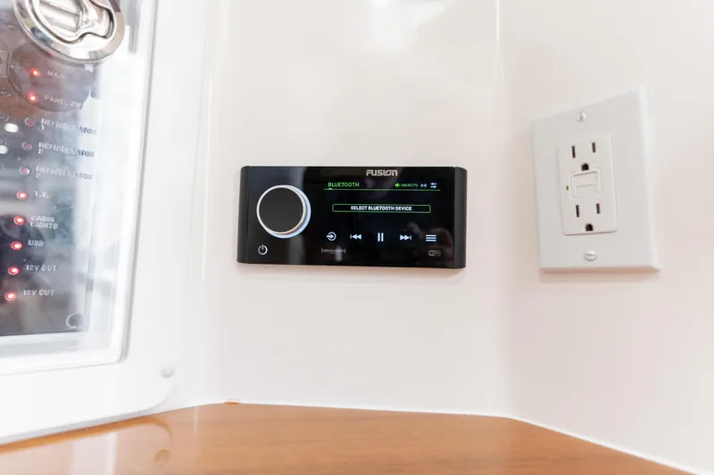 Slide: The Image of Control panel and outlet in 2026 Deep Impact 499 Sport Luxury Edition boat interior. - 65