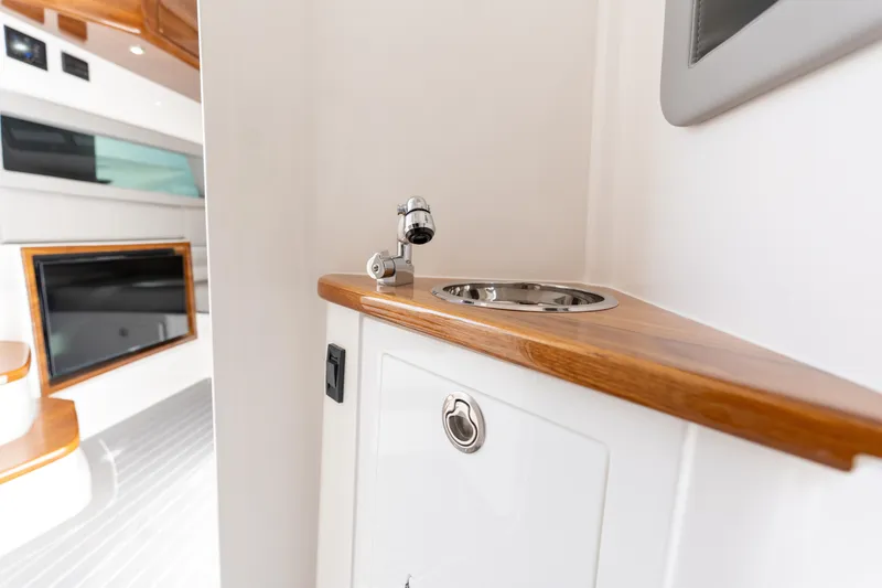 Slide: The Image of Interior of 2026 Deep Impact 499 Sport Luxury Edition boat with sleek sink design. - 69