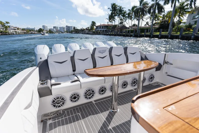 Slide: The Image of Luxury boat interior with white seating and wooden table, Deep Impact 499 Sport Luxury Edition 2026. - 77