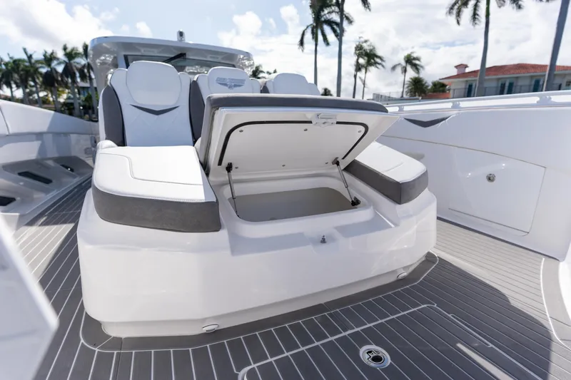 Slide: The Image of 2026 Deep Impact 499 Sport Luxury Edition boat with open storage compartment. - 83
