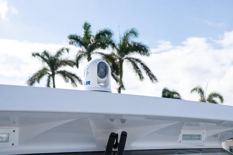 Slide: The Image of 2026 Deep Impact 499 Sport Luxury Edition boat with FLIR camera, palm trees in background. - 84