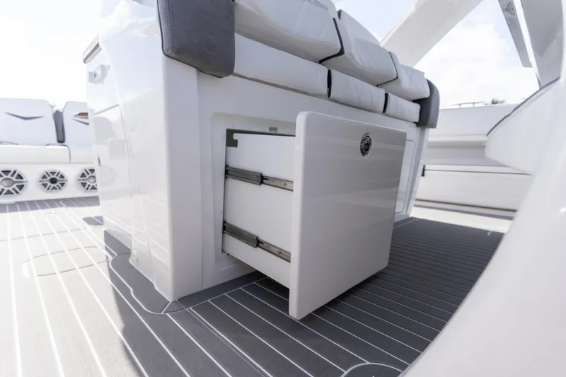 Slide: The Image of 2026 Deep Impact 499 Sport Luxury Edition boat interior with open storage compartment. - 86