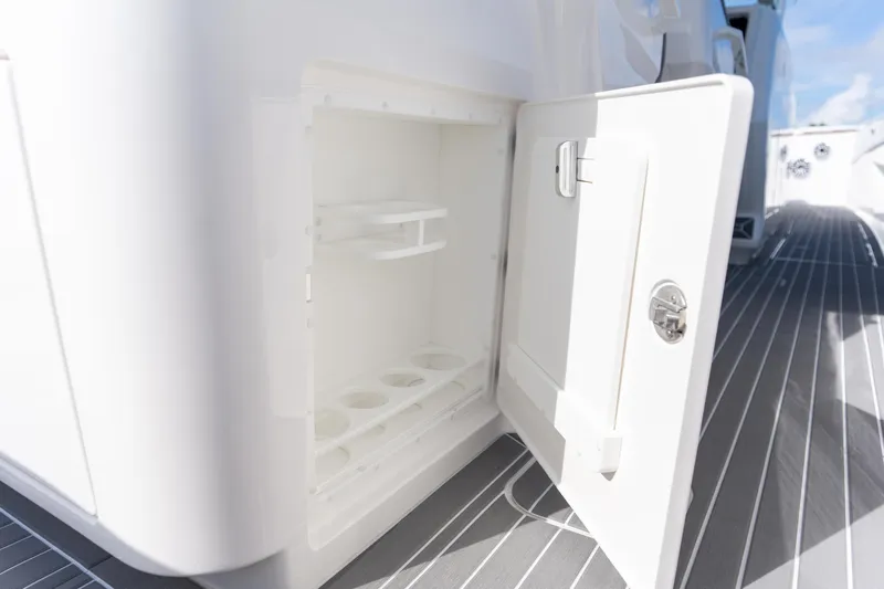 Slide: The Image of Open storage compartment on 2026 Deep Impact 499 Sport Luxury Edition boat. - 87