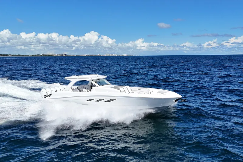 Slide: The Image of 2026 Deep Impact 499 Sport Luxury Edition boat cruising on open water. - 9