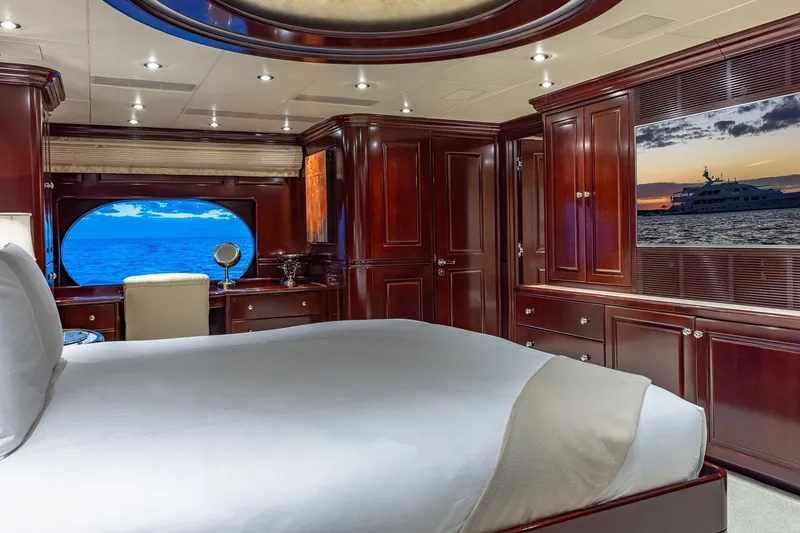 Slide: The Image of Luxurious 2007 Christensen Tri-Deck yacht bedroom with ocean view and elegant wood furnishings. - 10