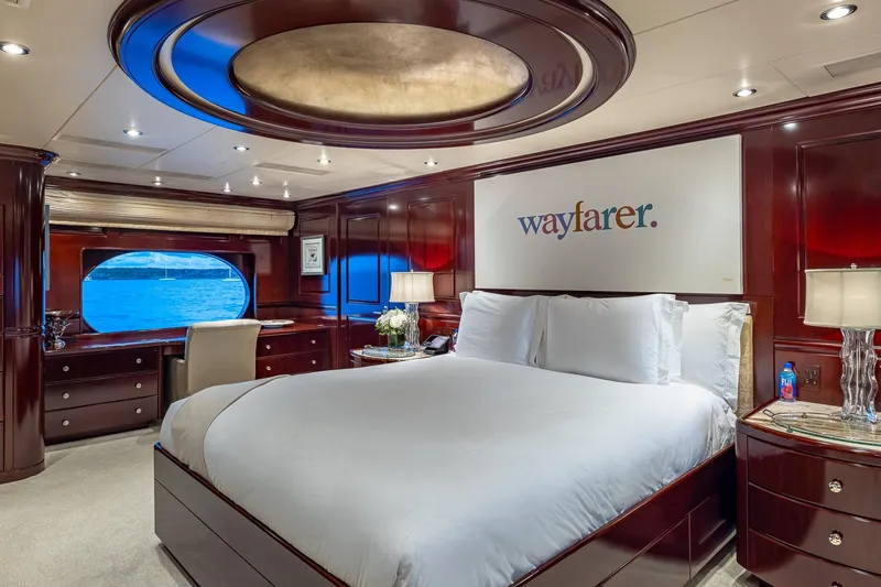 Slide: The Image of Luxurious bedroom on 2007 Christensen Tri-Deck yacht with elegant wood paneling and ocean view. - 11