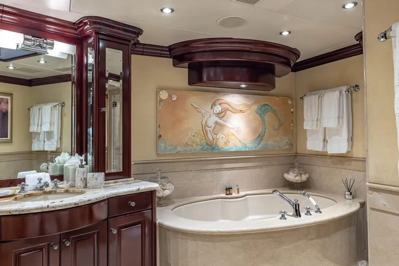 Slide: The Image of Luxurious yacht bathroom with mermaid artwork, marble fixtures, and elegant wood cabinetry, Christensen Tri-Deck 2007. - 15