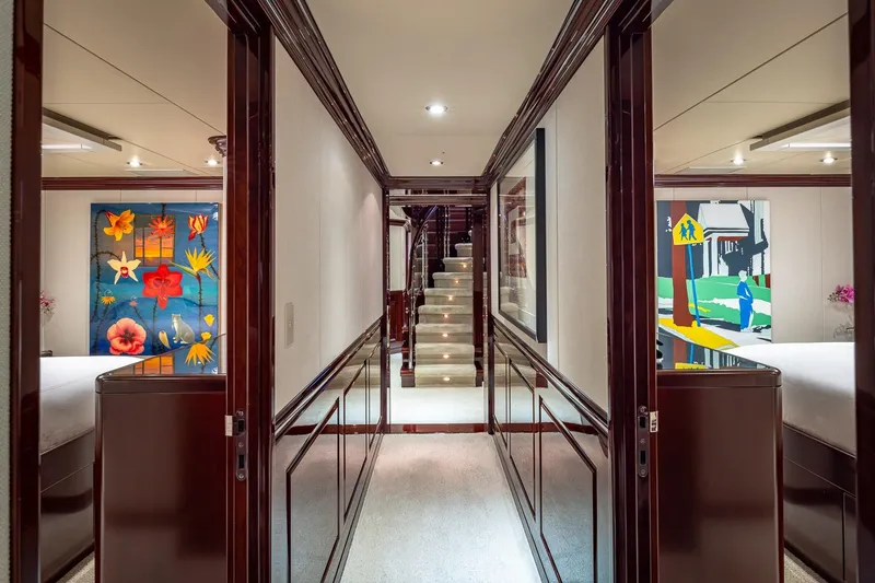 Slide: The Image of Luxurious hallway on 2007 Christensen Tri-Deck yacht with vibrant artwork and elegant decor. - 18