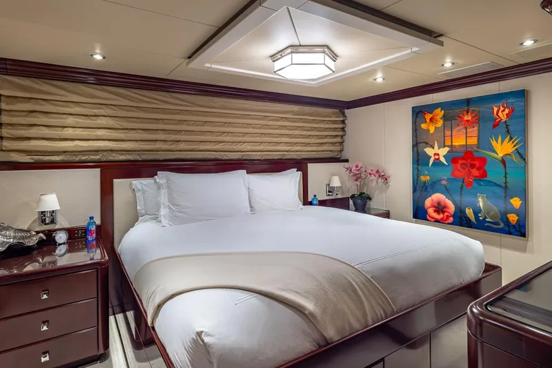 Slide: The Image of Luxurious bedroom on 2007 Christensen Tri-Deck yacht with elegant decor and vibrant floral artwork. - 19